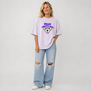 A woman modeling a light purple t-shirt with a 'CHLAX ATHLETIC CLUB' graphic featuring a cartoon koala, paired with light-wash ripped jeans and white sneakers, against a light gray studio background.