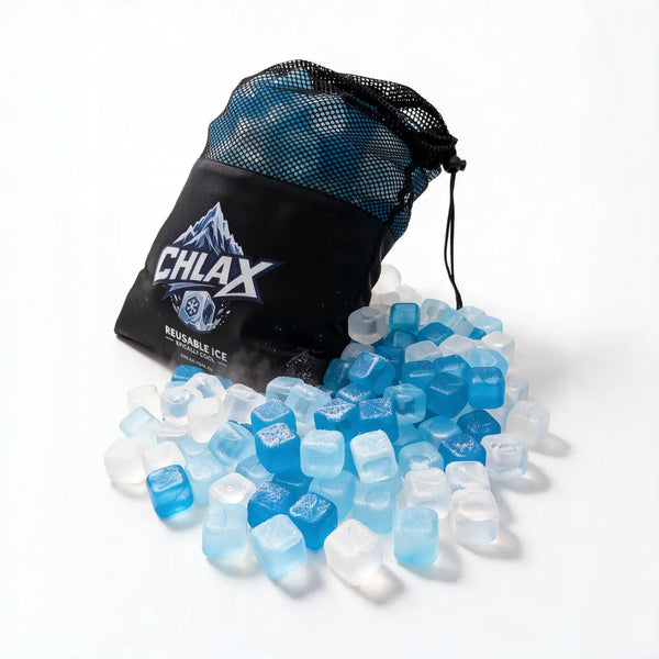 A black mesh drawstring bag with the brand name CHLAX printed on the front, with reusable ice cubes spilling out onto a white surface. The ice cubes are translucent and range from light blue to deep blue.