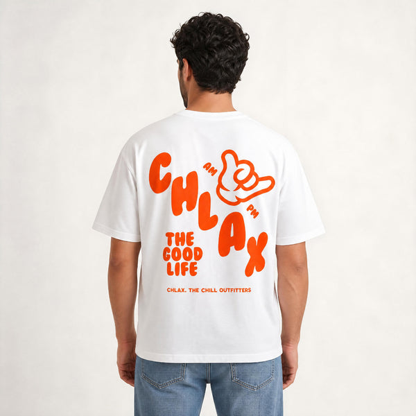 A man viewed from behind wearing a white t-shirt with a large orange graphic on the back that reads 'CHLAX THE GOOD LIFE' with a hand gesture logo, paired with blue jeans against a light gray background.