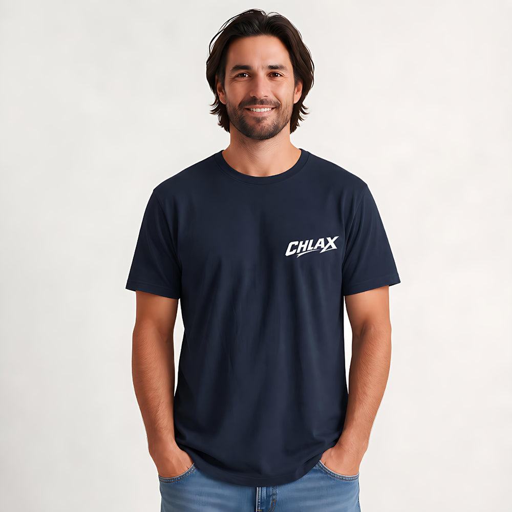 A man wearing a navy blue crewneck t-shirt with a white 'CHLAX' logo on the left chest, paired with blue jeans, standing against a light gray studio background.