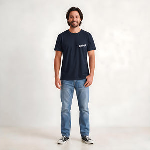 A man wearing a dark navy blue t-shirt with a white 'CHLAX' logo on the left chest, paired with light blue jeans and black sneakers, standing against a light gray studio background.