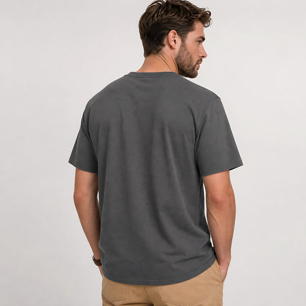 A man wearing a dark gray crewneck t-shirt, shown from the back and side against a plain light gray studio background.
