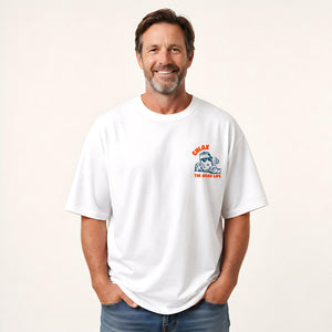 A man shown from the back wearing a white graphic t-shirt with a cartoon character and orange text that reads 'CHLAX. THE GOOD LIFE.