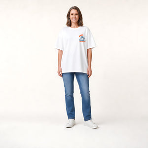 A woman shown from the back wearing a white graphic t-shirt with a cartoon character and orange text that reads 'CHLAX. THE GOOD LIFE.