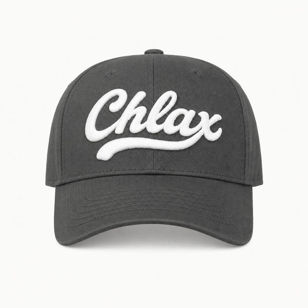 A dark gray baseball cap featuring the word 'Chlax' embroidered in white script across the front, set against a clean white background.
