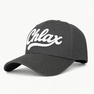 A dark gray baseball cap featuring the word 'Chlax' embroidered in white script across the front, set against a clean white background.