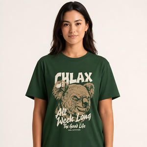 A woman wearing a dark green graphic t-shirt with a koala illustration and the text 'CHLAX All Week Long The Good Life'.