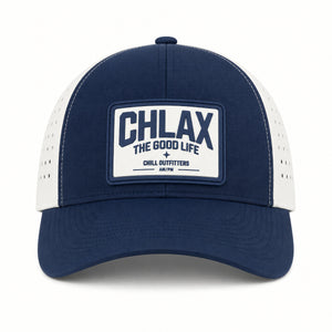 A navy blue and white trucker-style baseball cap with a white rectangular patch on the front that reads 'CHLAX THE GOOD LIFE CHILL OUTFITTERS AM/PM'.