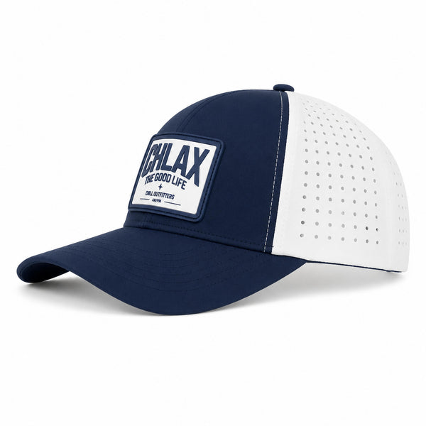 A navy blue and white trucker-style baseball cap with a white rectangular patch on the front panel. The patch features the brand name 'CHLAX' and the text 'THE GOOD LIFE' with smaller text 'CHILL OUTFITTERS'.