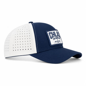 A navy blue and white trucker-style baseball cap with a white front patch reading 'CHLAX THE GOOD LIFE CHILL OUTFITTERS'.