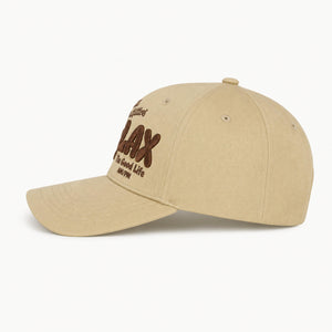 A khaki beige baseball cap with brown embroidered text on the front reading 'CHLAX' and 'The Good Life', shown on a clean white background.