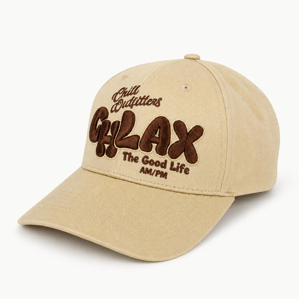 A beige baseball cap with brown embroidered text reading 'Chill Outfitters', 'CHLAX', and 'The Good Life AM/PM' on a clean white background.