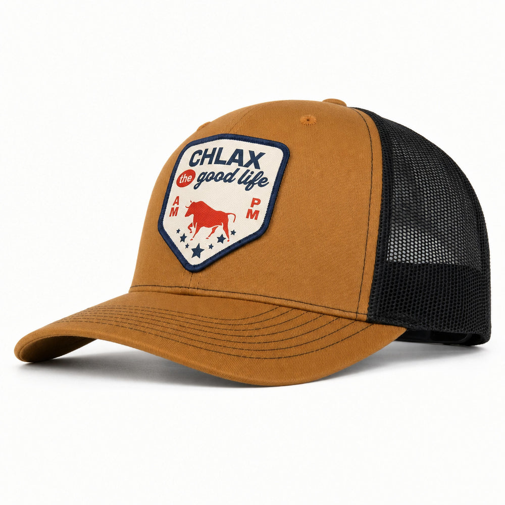 A brown and black trucker hat with a curved brim, featuring a front patch that reads 'CHLAX for good life' with a red bull graphic, set against a plain white background.