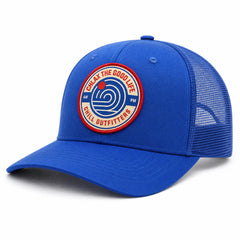 A royal blue trucker hat with a curved brim and mesh back panels, featuring a circular embroidered patch on the front that reads 'Chlax the Good Life Chill Outfitters' with a blue spiral logo.